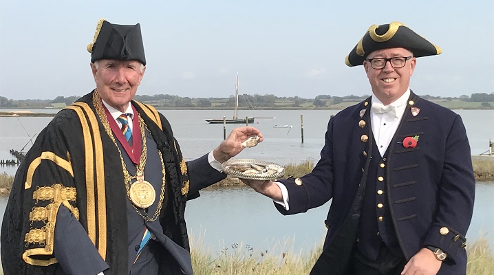 The Mayor and Town Serjeant of Colchester at Colne Oyster Fishery holding oysters
